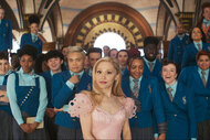 Glinda (Ariana Grande) is surrounded by students in Wicked (2024).