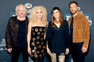 Jimi Westbrook, Kimberly Schlapman, Karen Fairchild and Phillip Sweet of Little Big Town smile together in front of a step and repeat.