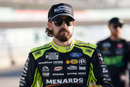 Ryan Blaney walks the grid wearing a hat and sunglasses