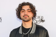 Adam Irigoyen wears a black and white jacket on the red carpet