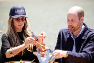 Heidi Klum helps serve Prince William some food on his plate