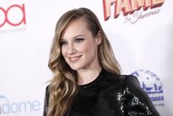 Danielle Savre smiles with a side part in her hair.