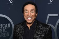 Smokey Robinson smiles in a jacquard jacket.