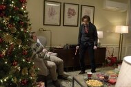 Beck Bennett, next to the Christmas tree, cowers at Ryan Gosling on SNL Episode 1690.