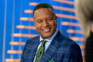 Craig Melvin smiles at a co-anchor on the Today show