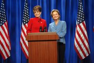 Governor Sarah Palin (Tina Fey) and Senator Hillary Clinton (Amy Poehler) stand behind a podium on Saturday Night Live Epsiode 1532.