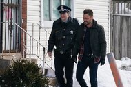 Bob Ruzek (Jack Coleman) and Adam Ruzek (Patrick John Flueger) walk together past houses on Chicago P.D. Episode 810.