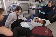 A doctor uses a stethoscope on conjoined twins (Jason and Victor Turner) on Chicago Med Episode 1010.