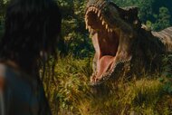 Luna Blaise watches a T-Rex roar and bare its teeth in Jurassic World Rebirth (2025).