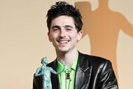 Timothée Chalamet posing with his award at the 31st Screen Actors Guild Awards.