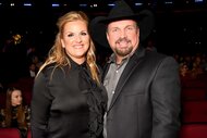 Trisha Yearwood and husband Garth Brooks smiling together at the 2019 iHeartRadio Music Awards.