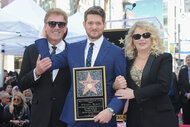 Michael Buble holds a plaque with his parents at the hollywood walk of fame ceremony