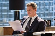 Ted Black looking at a paper while at a desk in Suits LA Season 1, Episode 1.