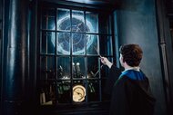 A guest holding up a wand in Universal Orlando's The Wizarding World of Harry Potter.