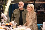 Martha Stewart and José Andrés standing around a table with food and cooking utensils on Yes, Chef!