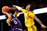 Boo Buie #0 of the Northwestern Wildcats goes up for a shot against Elijah Hawkins #0 of the Minnesota Golden Gophers.