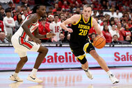 ayton Sandfort #20 of the Iowa Hawkeyes and Aaron Bradshaw #4 of the Ohio State Buckeyes on the basketball court