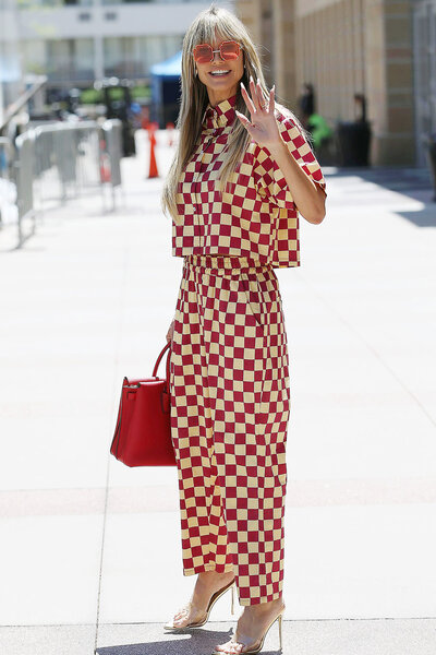 Heidi Klum wearing red and white checkered pants with a matching collared top