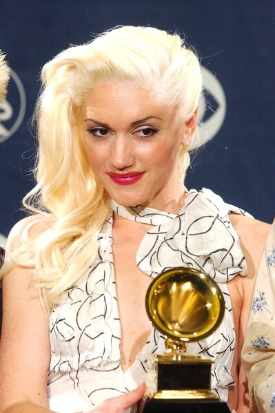 Gwen Stefani holding her Grammy award at the 2004 Grammy's.