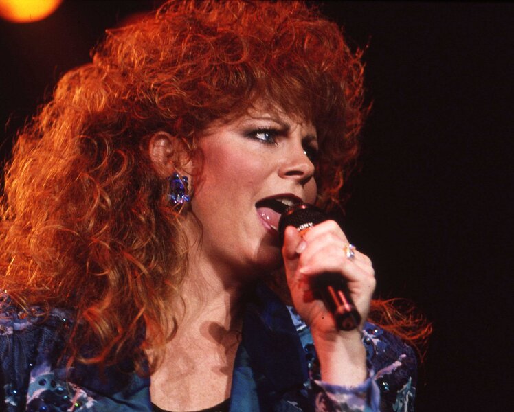 Reba McEntire performing on stage.