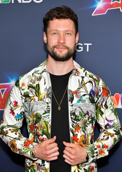 Calum Scott posing on the America's Got Talent carpet.