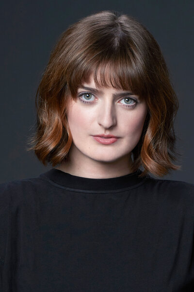 A headshot of Chloe Troast for Saturday Night Live