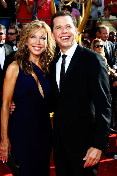 Lisa Joyner and Jon Cryer pose in all black on the red carpet at the 60th Primetime Emmy Awards