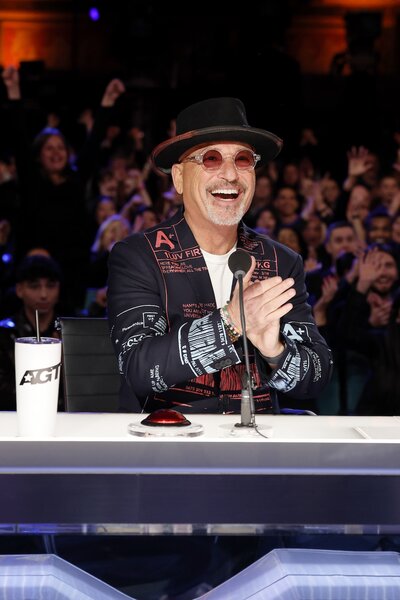 Howie Mandel smiles and claps on America's Got Talent Episode 1903.