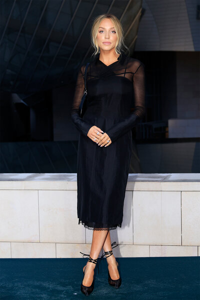 Alex Cooper wears a black dress to the prelude to the 2024 olympics