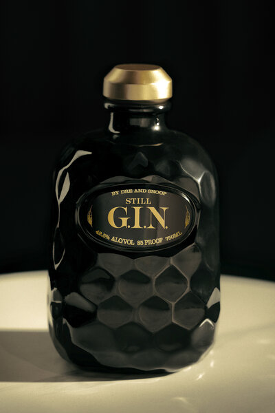 A black bottle of Still Gin with a gold top