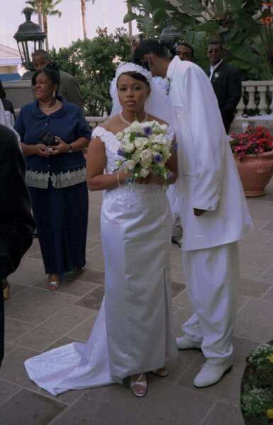 Snoop Dogg and Shante Broadus match in white at their wedding.