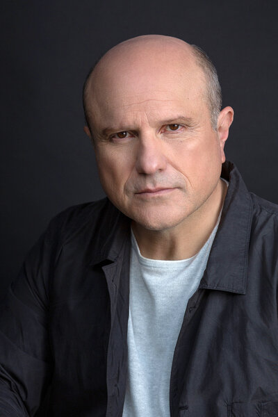 A headshot of Enrico Colantoni