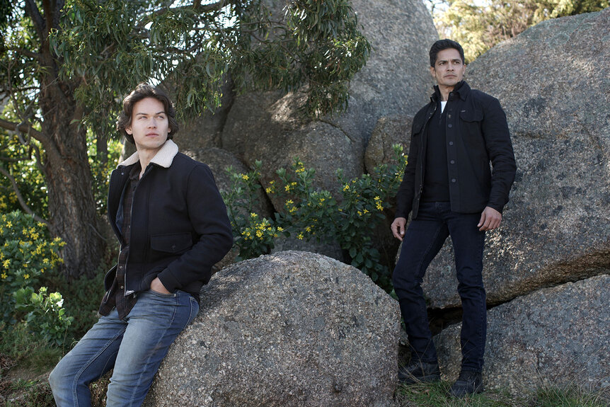 La Brea actors sitting on large rocks