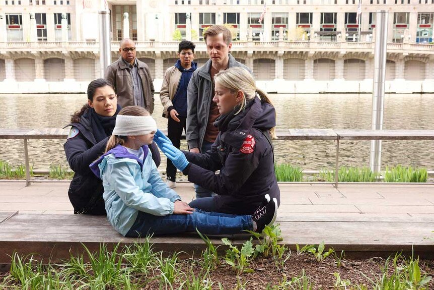 Violet Mikami (Hanako Greensmith) and Sylvie Brett (Kara Killmer) gathered around Charlotte (Ava Ryan Barabasz).