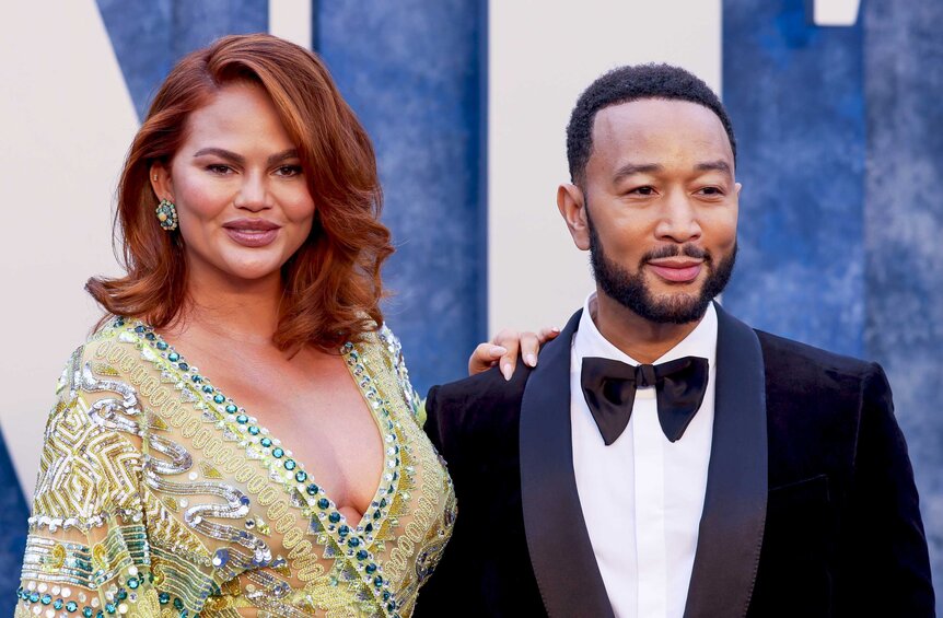 Chrissy Teigen and John Legend posing on the red carpet.