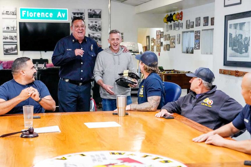 Cast of LA Fire & Rescue having a meeting.