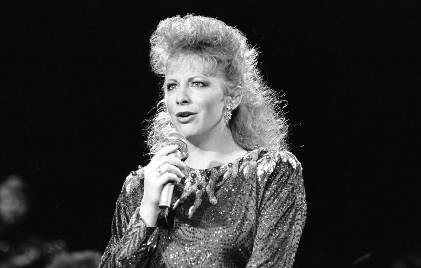 Reba McEntire performing on stage.