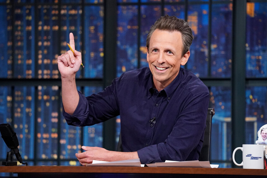 Seth Meyers sits behind his desk while hosting 'Late Night with Seth Meyers'