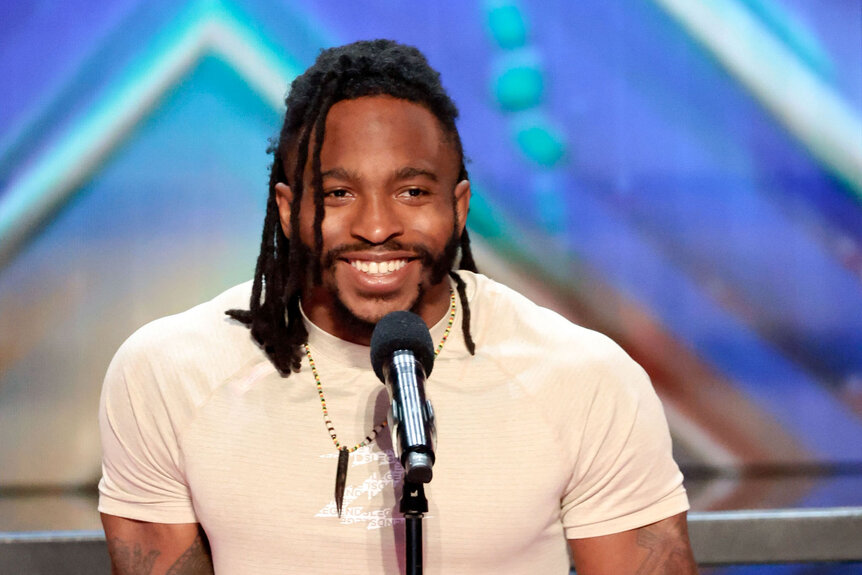 Zion Clark smiling on the America's Got Talent stage.