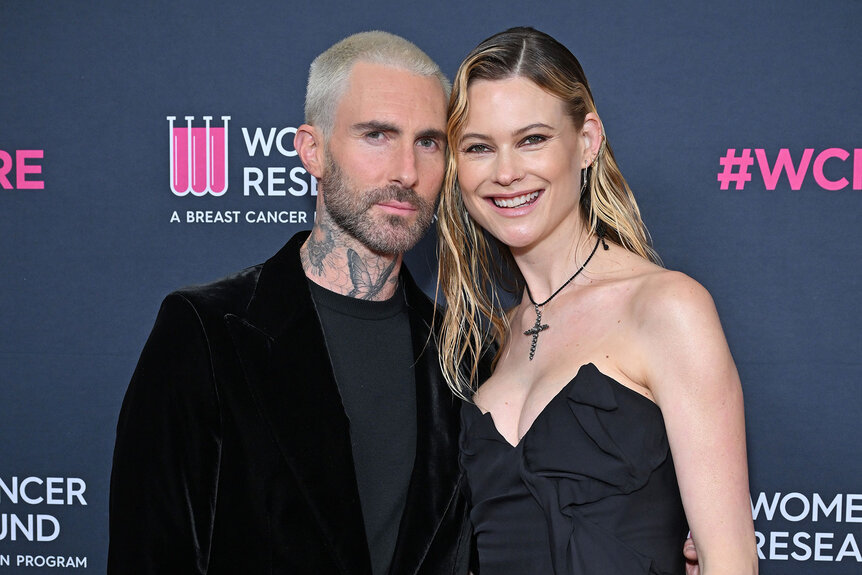 Adam Levine and Behati Prinsloo pose on a red carpet