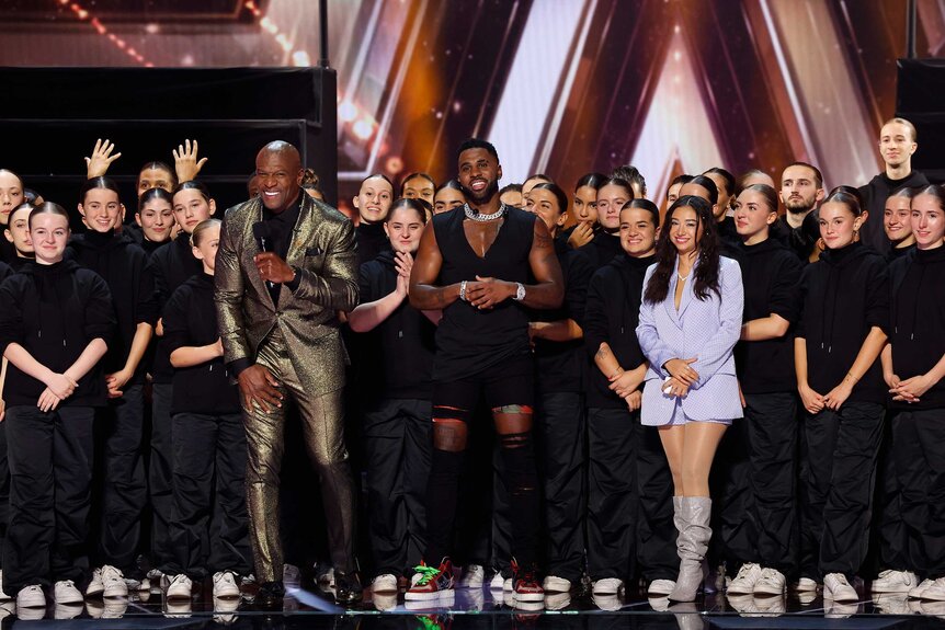 Terry Crews, Jason Derulo, Murmuration, and Anna Deguzman standing together on stage.l