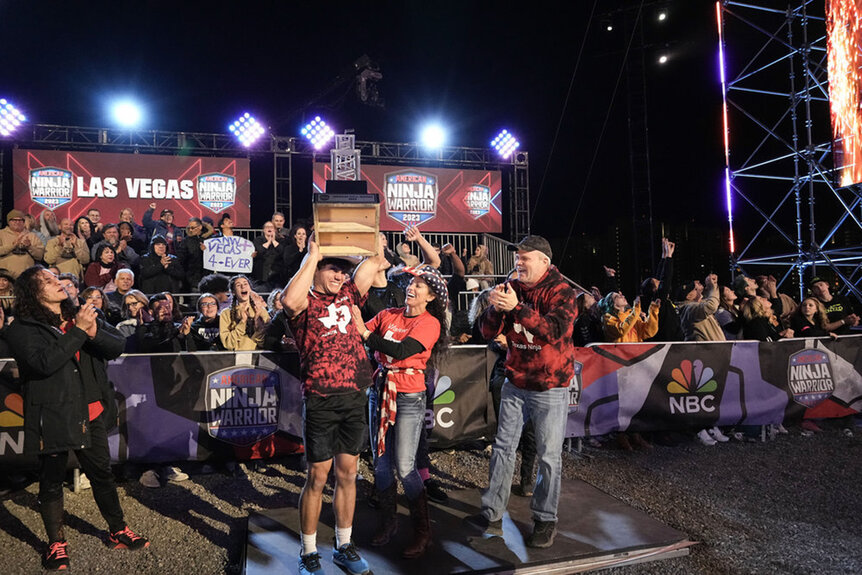 Winner Vance Walker holds a trophy over his head on American Ninja Warrior season 15 episode 16