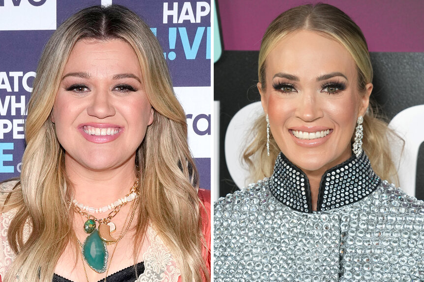 (l-r) Kelly Clarkson smiling and Carrie Underwood smiles wearing a silver jacket