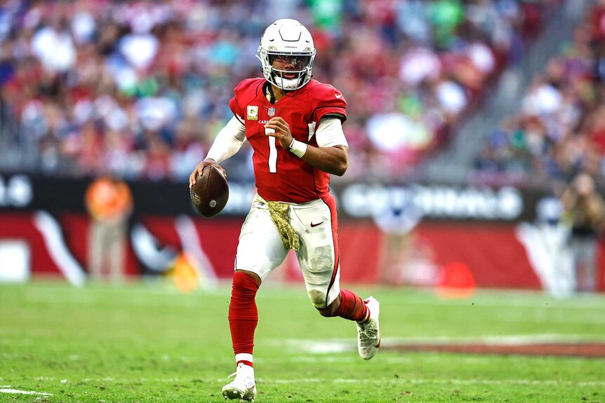 Arizona Cardinals Kyler Murray scrambles looking to pass the football.