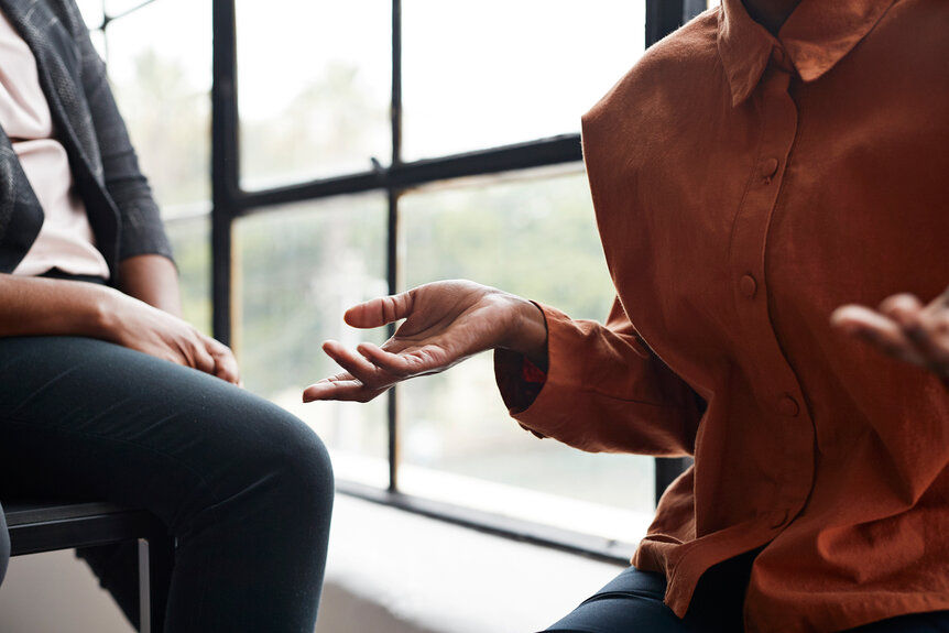 Two anonymous people having a conversation using their hands