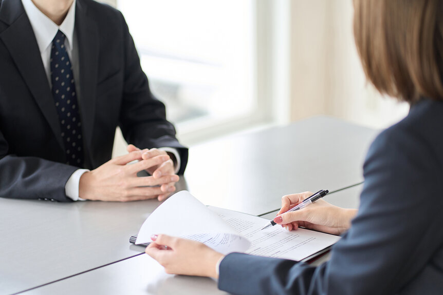 A woman interviewing a man for a job