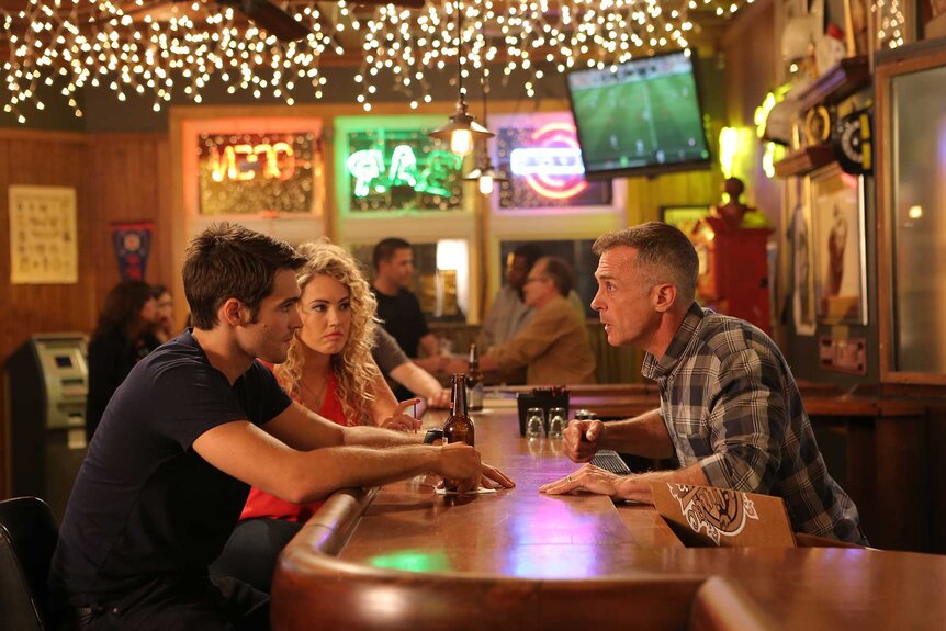 Jimmy Borelli sitting across the bar and having a conversation with Christopher Herrmann.