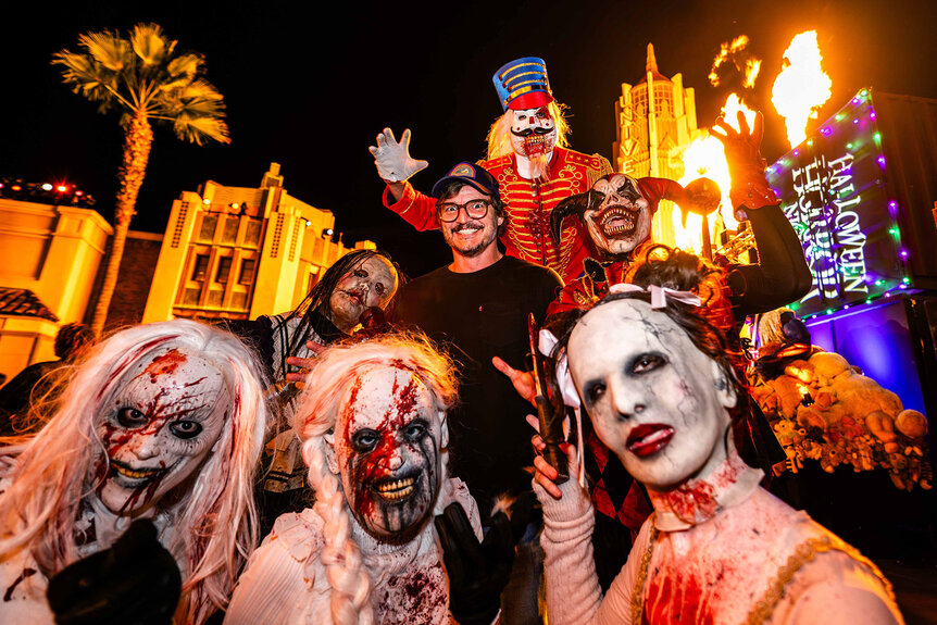 Pedro Pascal poses with costumed characters from Halloween Horror Nights