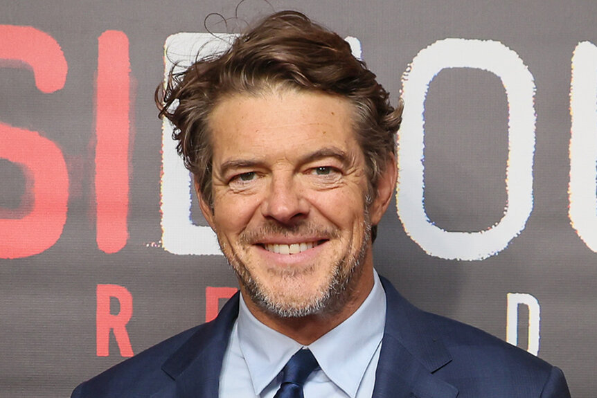 Jason Blum smiles on the red carpet