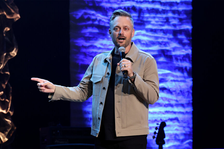 Nate Bargatze stands on stage during his comedy set